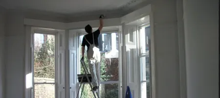 Painter Painting the Exterior of a Home